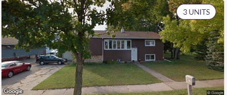 A house with a red car parked in front.