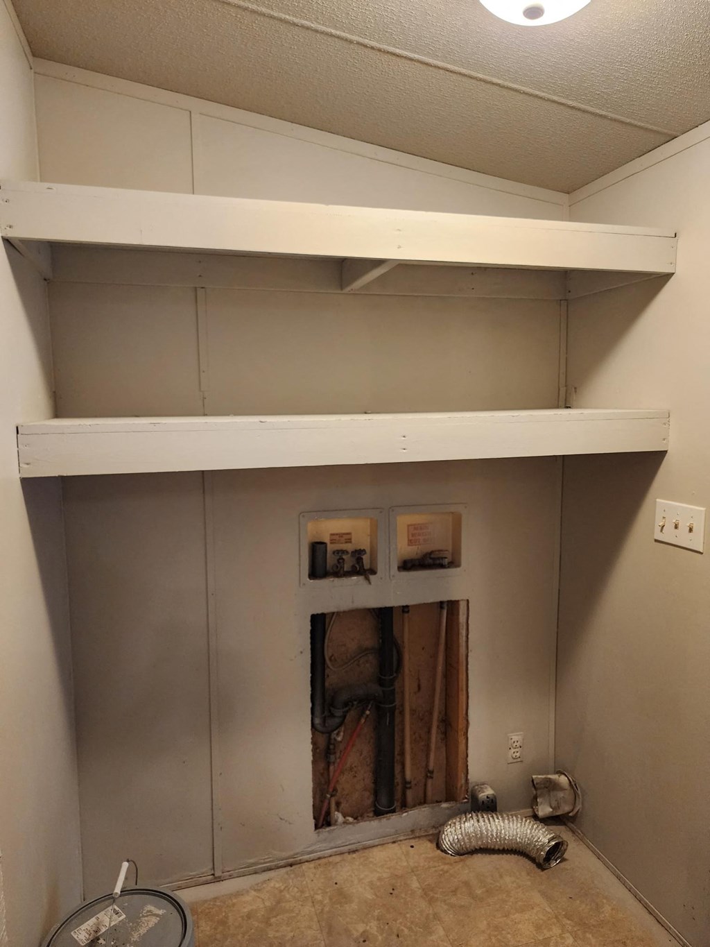 a room with a fireplace and a shelf on top of it