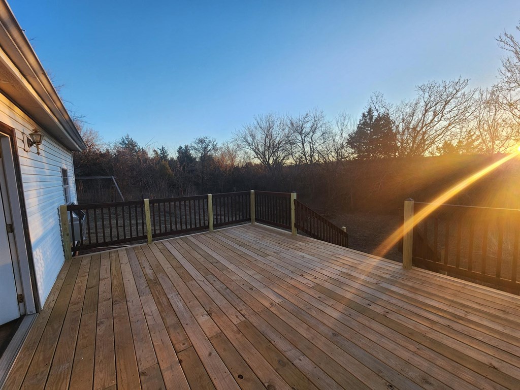 the deck of a home with the sun shining on it