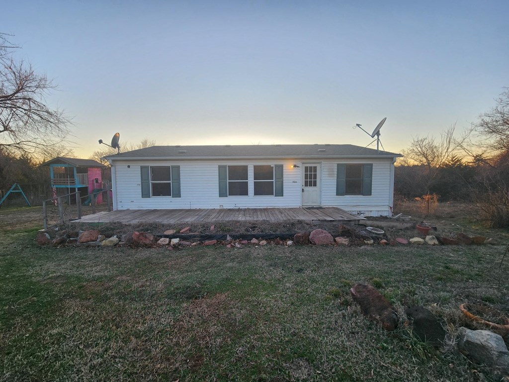 a small white tiny house with two wind turbines on the side of it