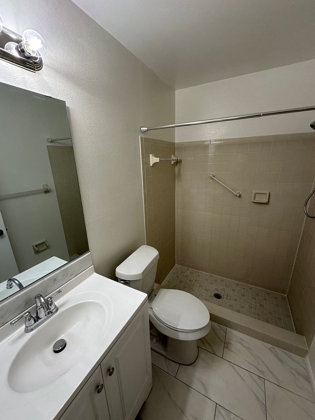 an image of a bathroom with a sink toilet and shower