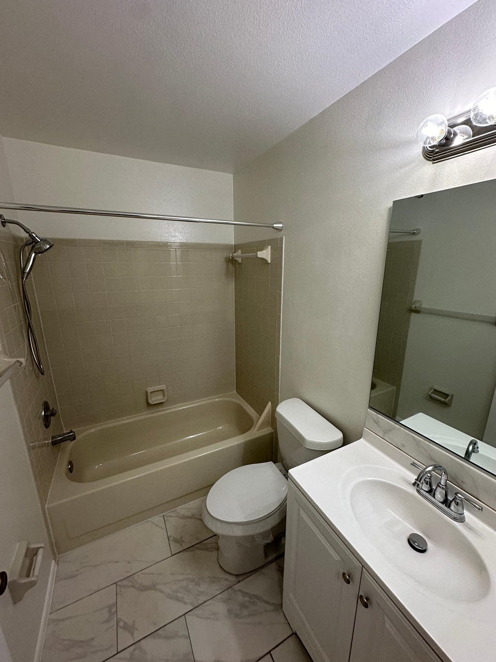 a bathroom with a toilet and a sink and a bath tub