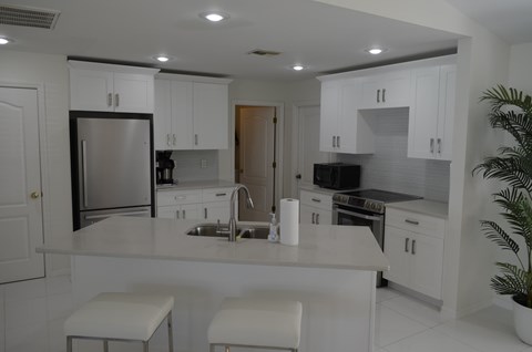 a kitchen with white cabinets and a counter top