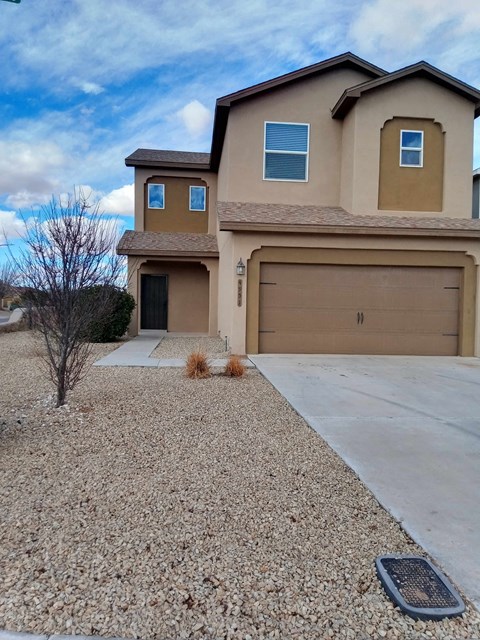 A house with a brown garage door and a driveway.