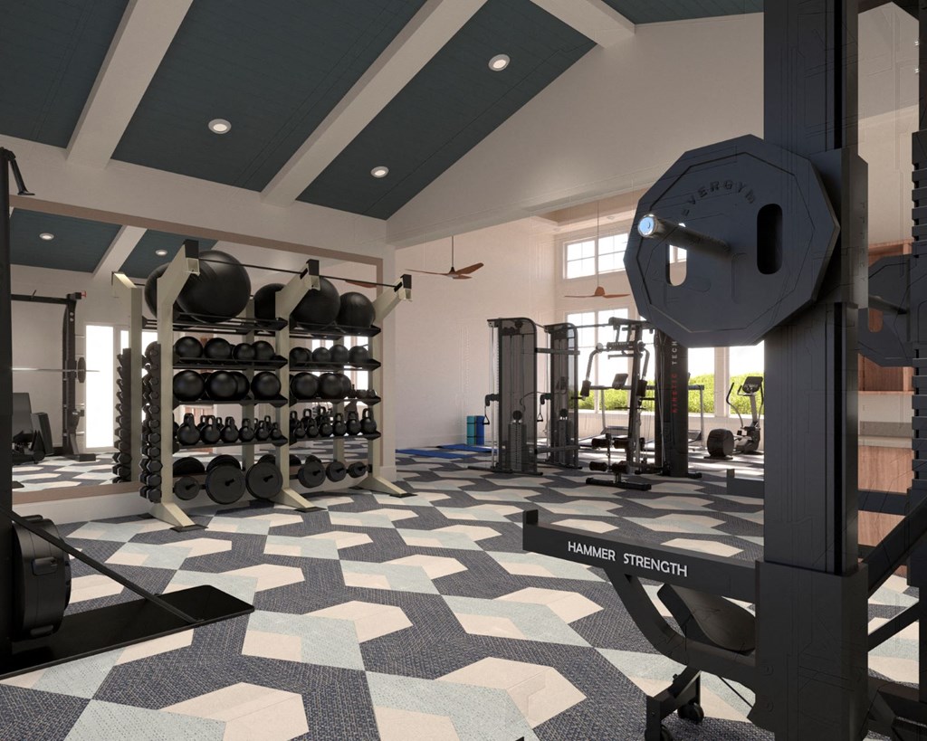 a gym with weights and a weights rack in the center of the room