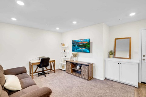 a living room with a couch and a desk