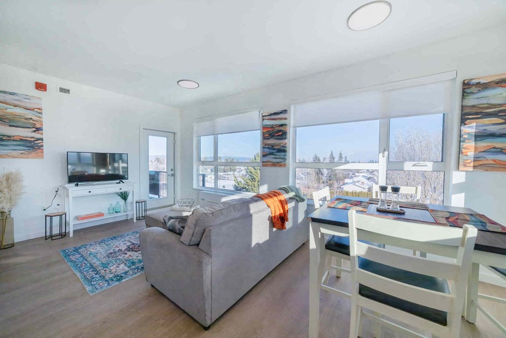 a living room with a couch and a table and a television