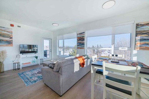 a living room with a couch and a table and a television