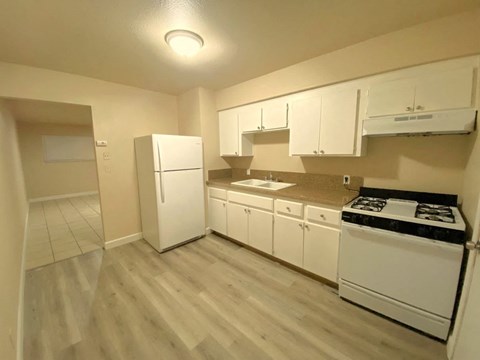 a kitchen with white appliances and white cabinets