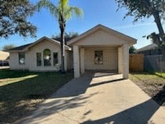 a house with a driveway and a palm tree