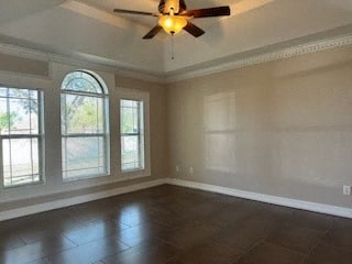 an empty living room with a ceiling fan and windows