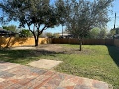 a backyard with trees and a brick patio
