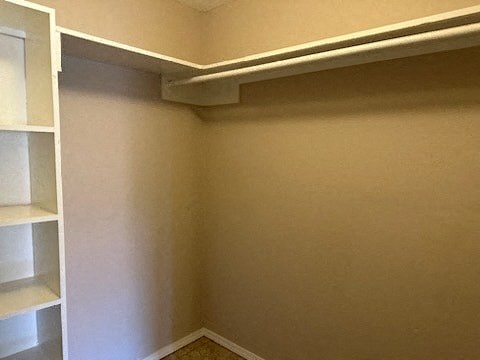 a corner of a room with a closet and shelves
