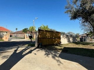 a wooden fence in the middle of a dirt road