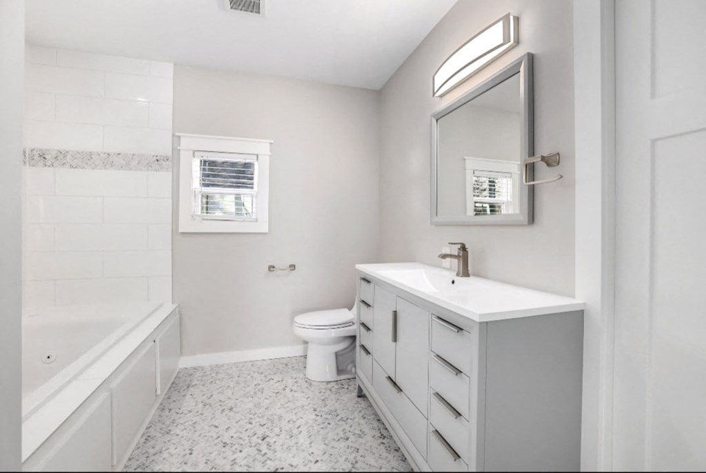 a white bathroom with a sink and a toilet