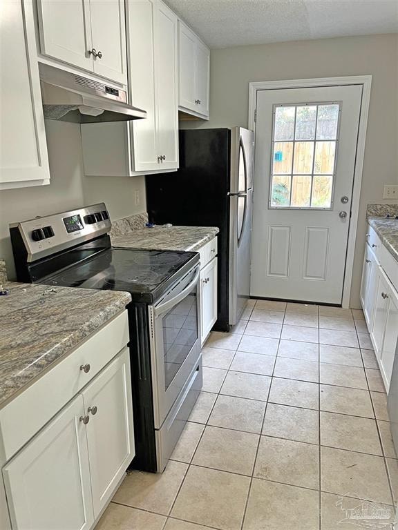 a kitchen with white cabinets and a black refrigerator