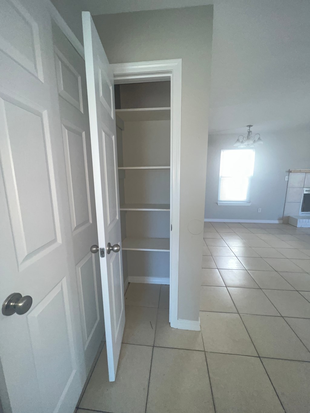 a room with a closet and a tiled floor