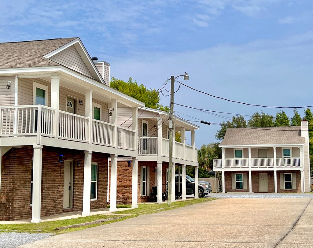 a row of houses with balconies and a parking lot