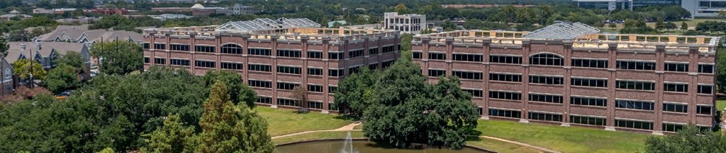 an aerial view of an old building with trees in front of it