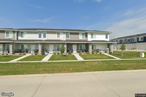 A street view of a residential area with apartment buildings.