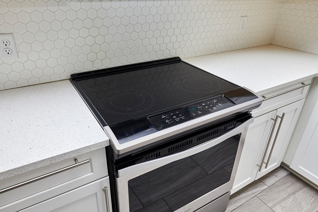 A black stove top oven sits on a white countertop.