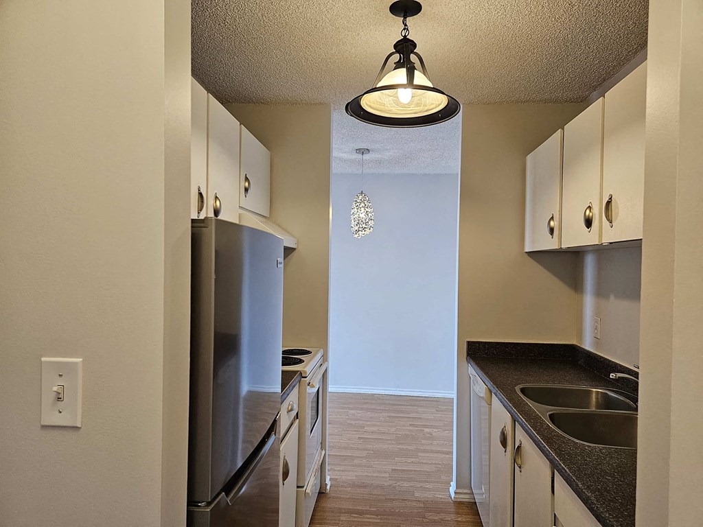 a kitchen with stainless steel appliances and white cabinets