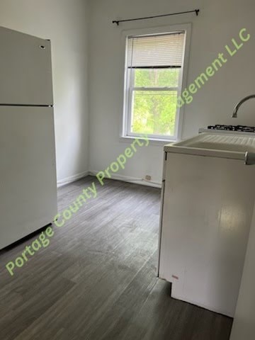 A kitchen with a white fridge and a white stove top oven.