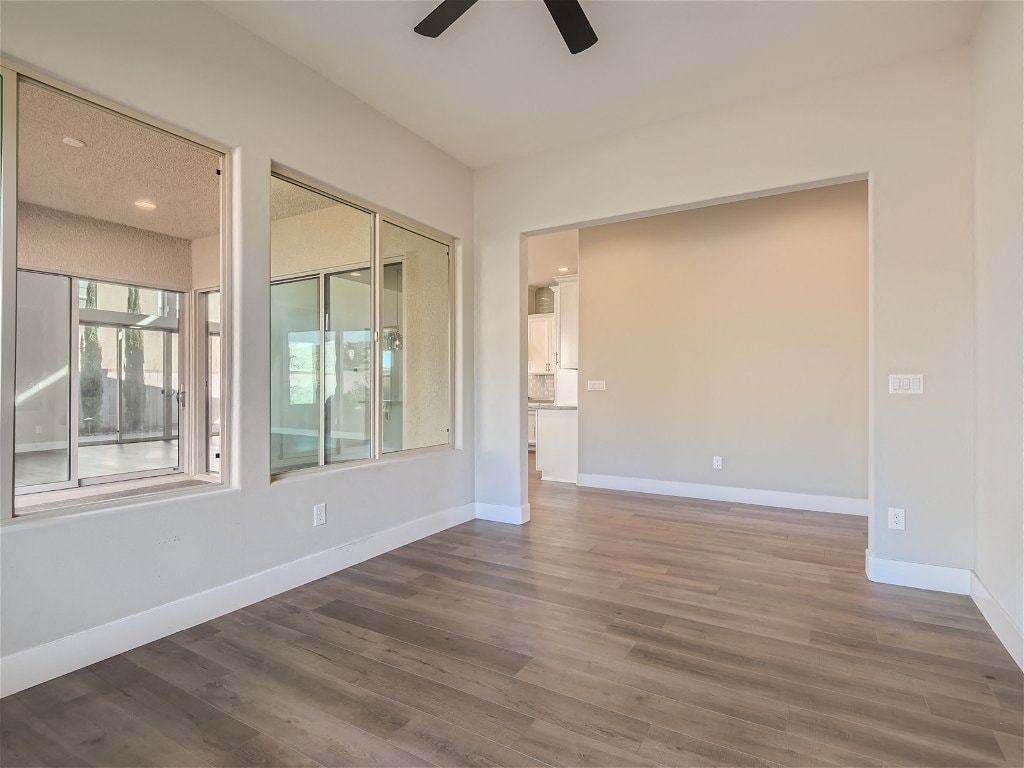 a living room with a hard wood floor and windows