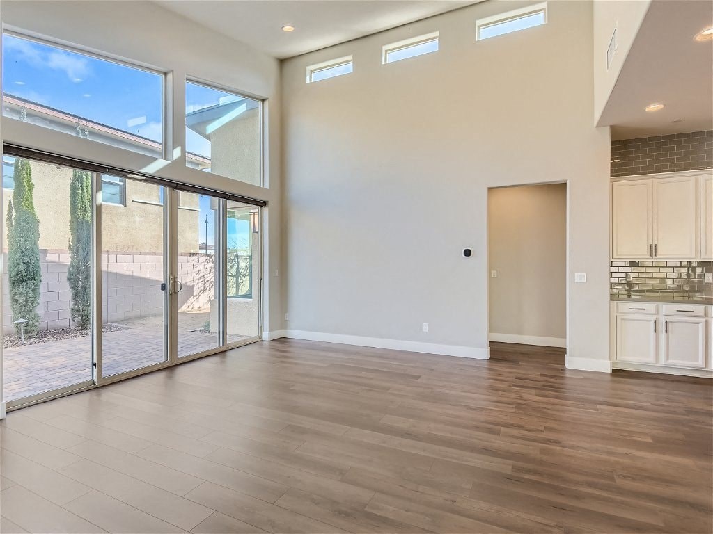 an empty living room with a sliding glass door to a patio