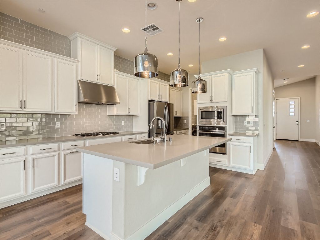 a large white kitchen with a large center island