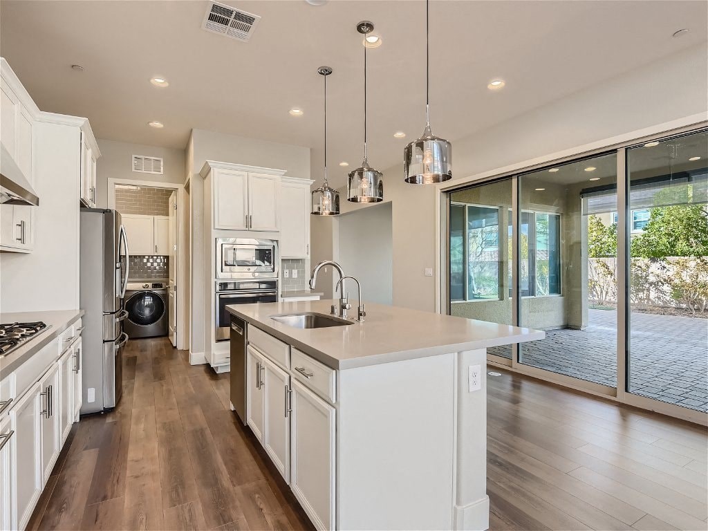 a large kitchen with a sink and a counter top