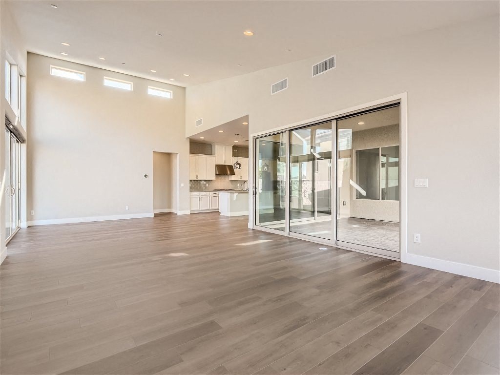 the living room and dining room of a new home with a large glass sliding door