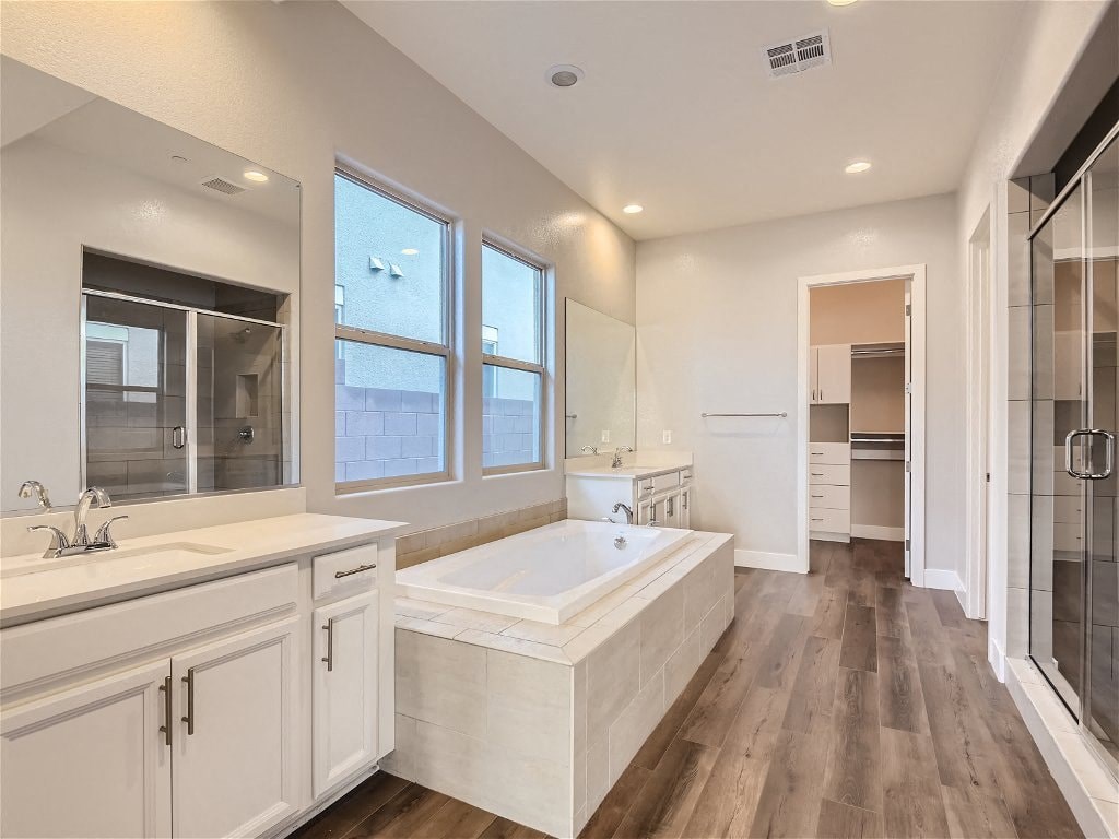 a large white bathroom with a tub and a sink