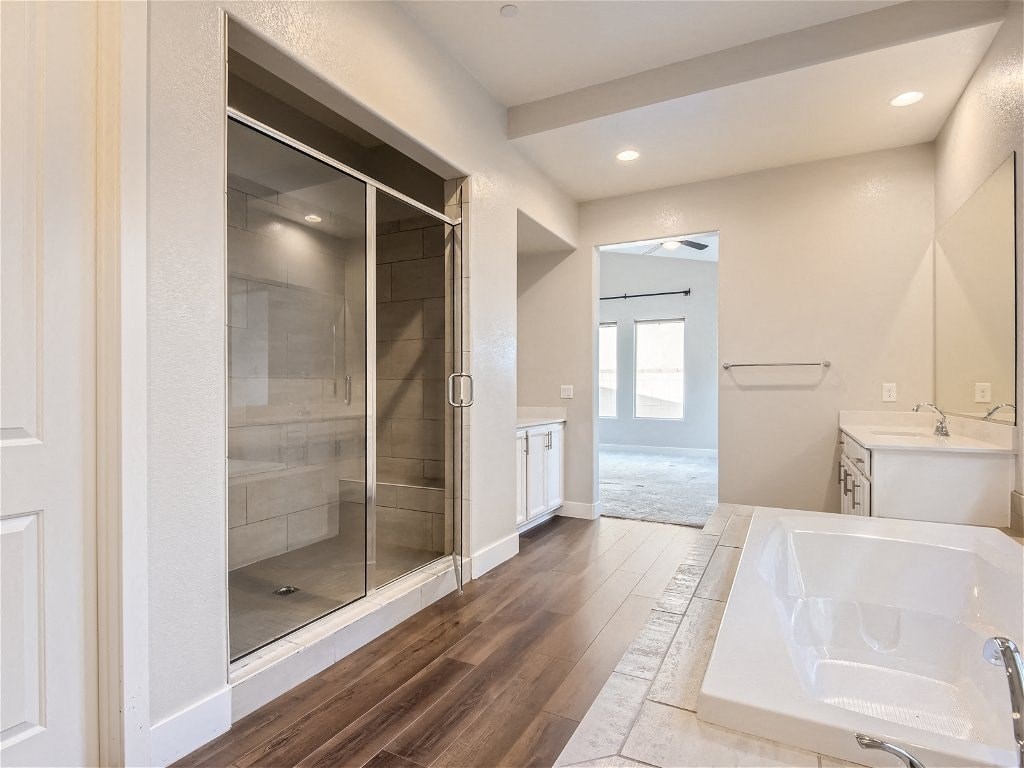 a bathroom with a shower and a sink in a house