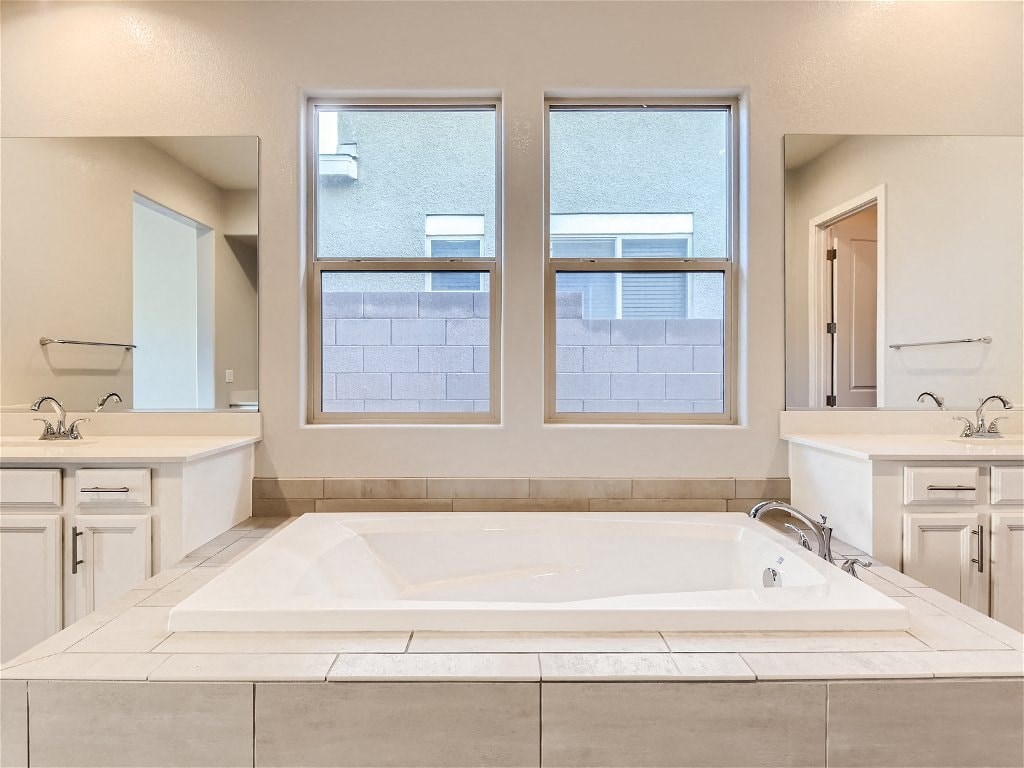 a bathroom with a large tub and two windows