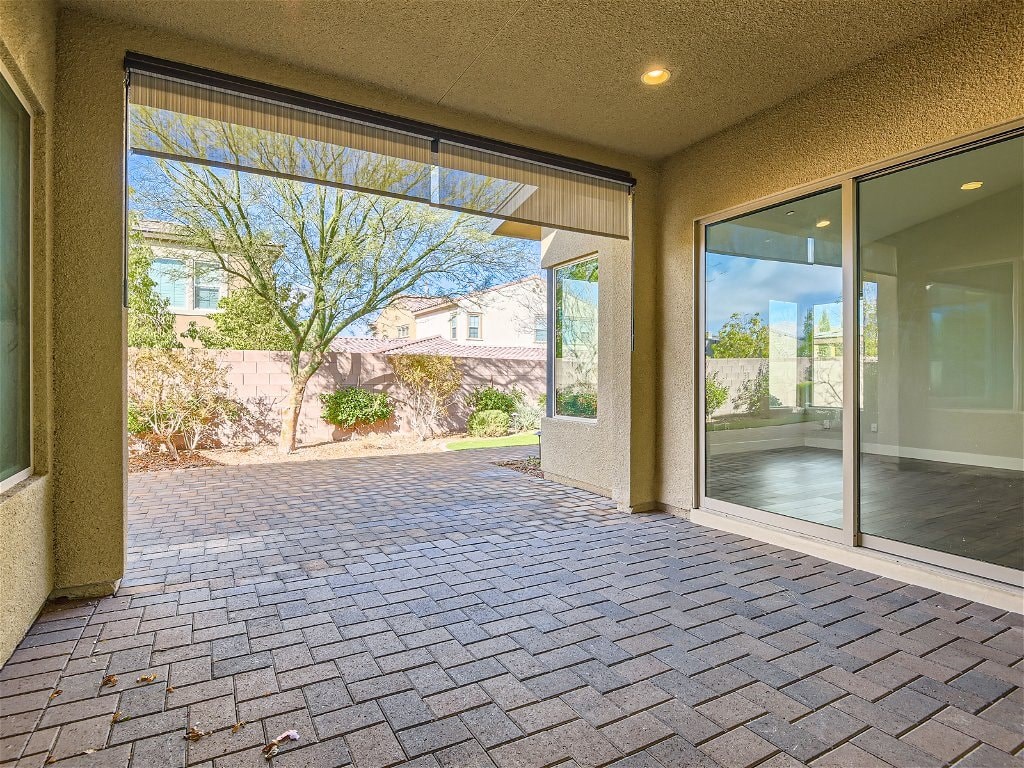 a patio with a brick floor and a glass door