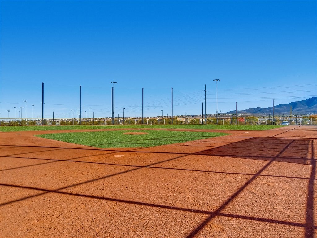 a baseball field with electricity poles on it