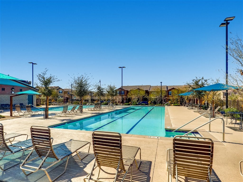 a swimming pool with chairs and umbrellas at the resort