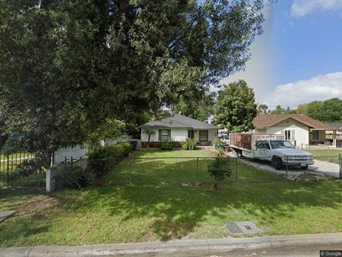 a truck parked in a yard in front of a house