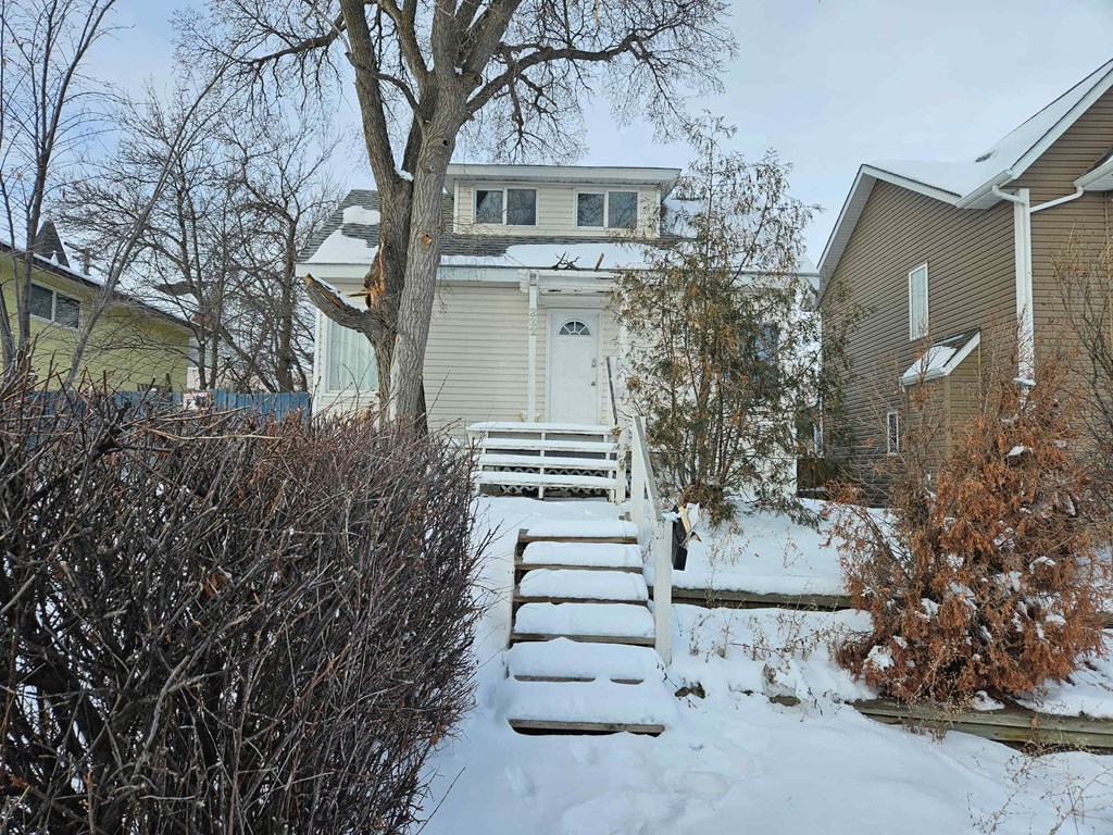 a house with snow covered steps in front of it