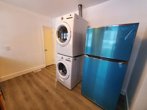 a washing machine next to a refrigerator in a room