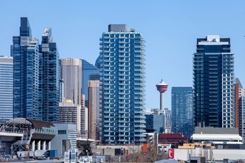 a city skyline with the calgary tower and other tall buildings
