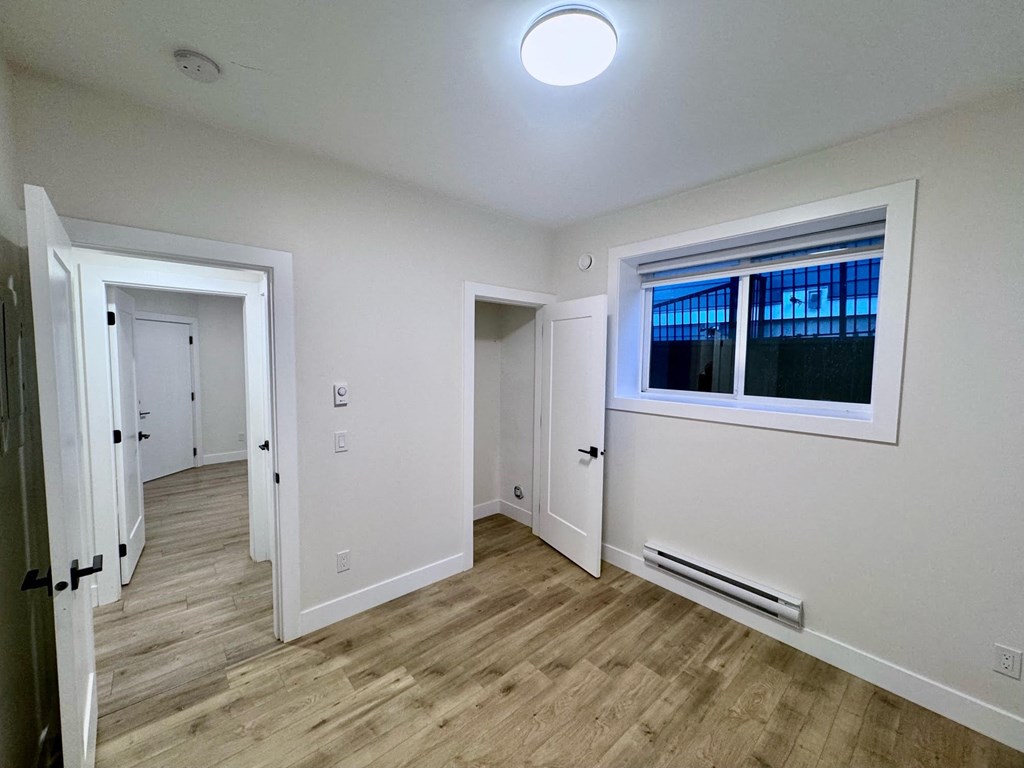 a living room with white walls and a window