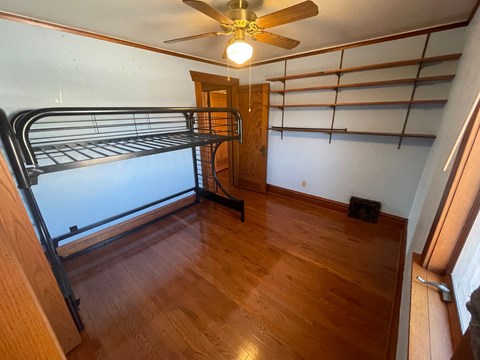a bedroom with a bunk bed and a ceiling fan