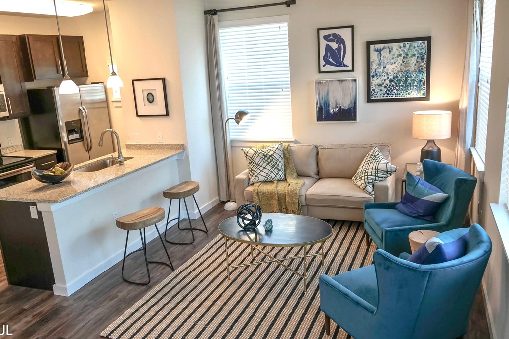 a living room with a couch and a table and a kitchen