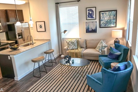 A living room with a couch, chair, and a coffee table.