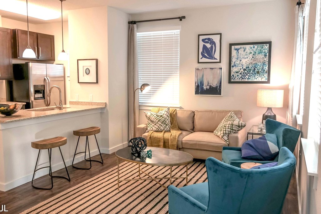 a living room with a couch and a table and a kitchen