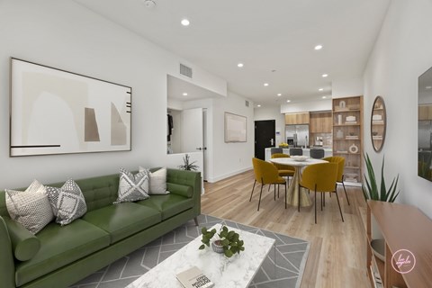 A living room with a green couch and a coffee table.