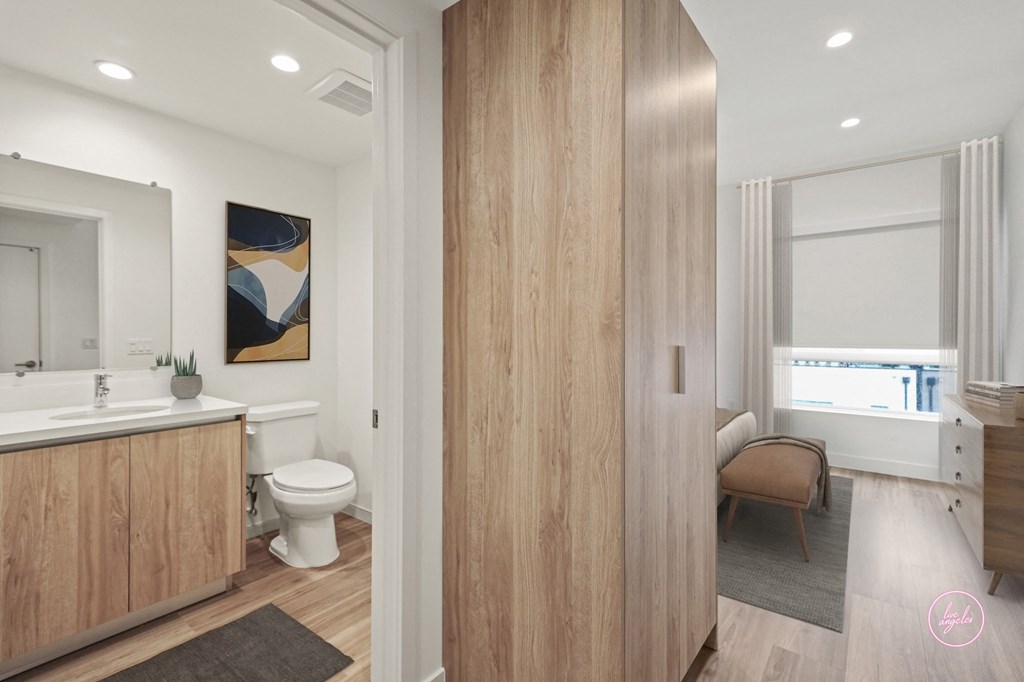 a bathroom with a toilet and a sink and a mirror