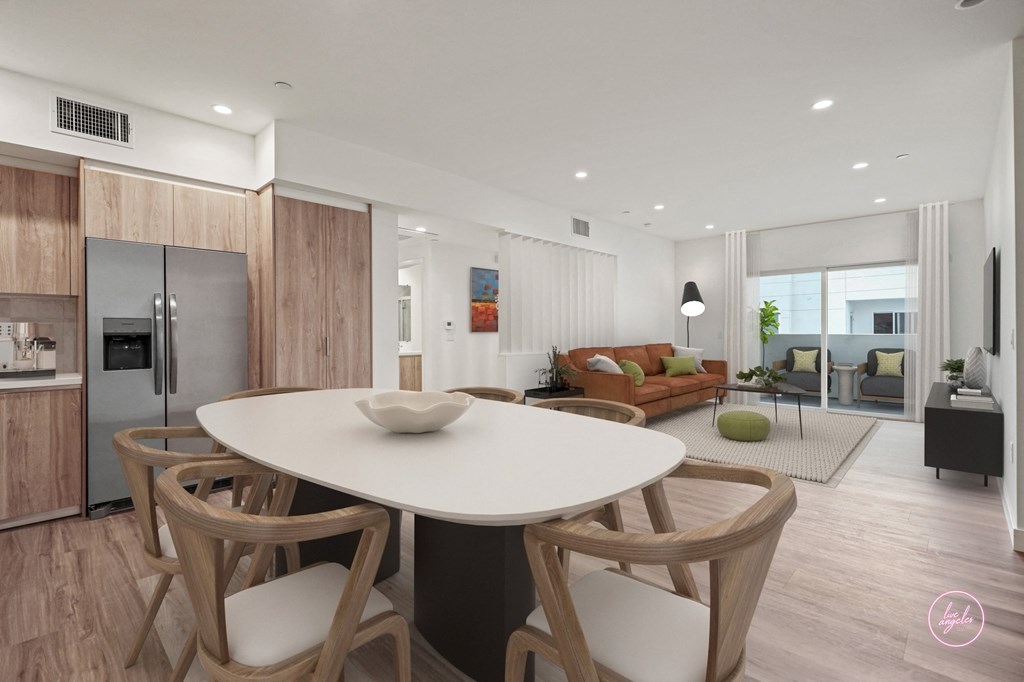a kitchen and living room with a white table and chairs